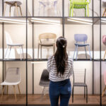 Rear view of a Latin American woman buying chairs at a furniture store - business concepts