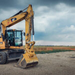 Belgrade, SRB, Serbia - July 26, 2020: Yellow CAT industrial excavator parked at the construction site in Belgrade, Serbia. The photo was made on July 26, 2020 afternoon. The photo contains no people, only CAT excavator.