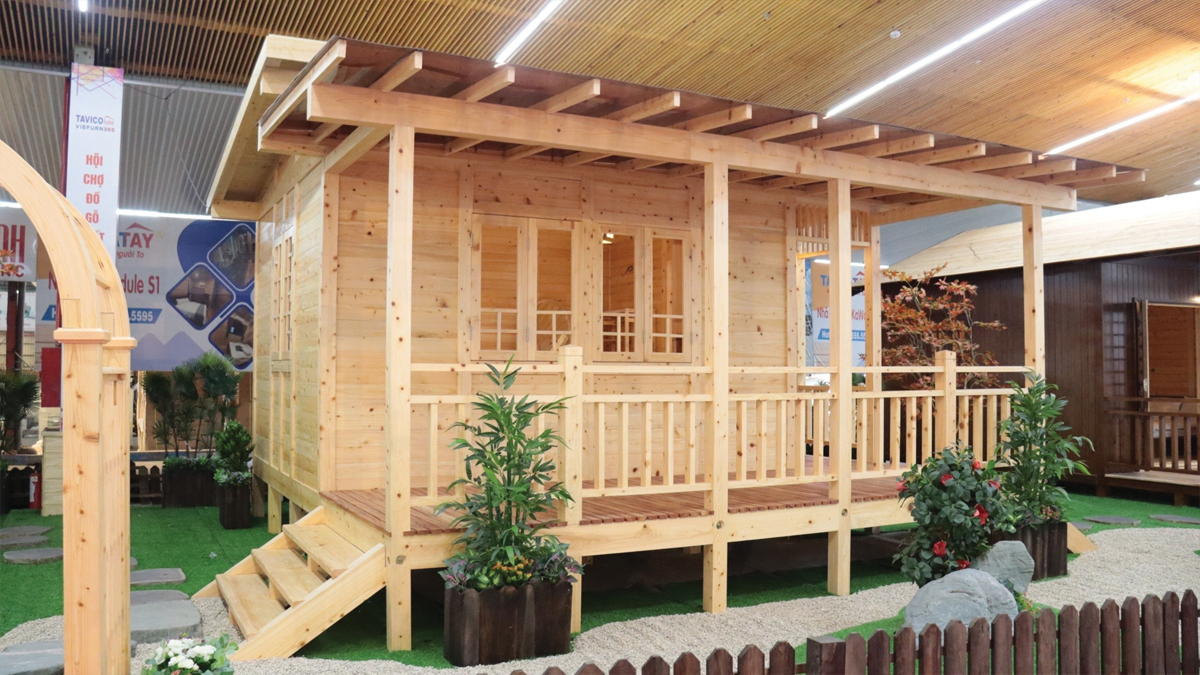 Ground level of green leaf on pyramid of pellets placed near stack of chopped firewood of various types and biomass briquettes in daylight