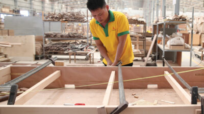 Production line of the wooden floor factory. CNC automatic woodworking machine. Industrial background