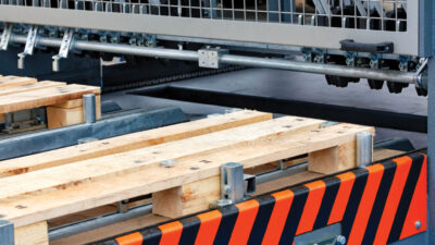 Production of wooden pallets on a modern automatic line, a fragment of the connection of wooden planks.