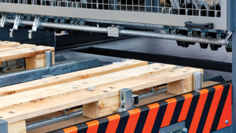 Production of wooden pallets on a modern automatic line, a fragment of the connection of wooden planks.