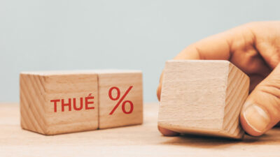 tax settlement in 2023, a wooden block with the date of submission of the tax return, the word TAX and the percentage symbol