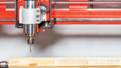 The metal cutter is fixed in the collet mechanism of the drilling-milling machine with a fixed electric spindle for processing wood in the manufacture of cabinet furniture.
