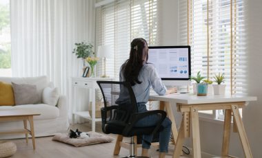 Smart Gen Z tech talent workforce typing SEO sale report on desktop PC happy work easy relax at home office. Remote WFH reskill upskill job MBA study of young people asia woman examine big data graph.