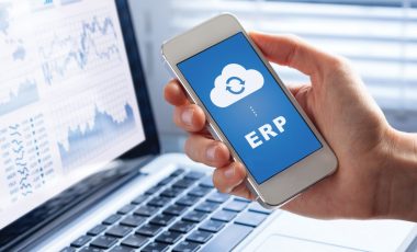 ERP (Enterprise Resource Planning) app on smartphone screen connecting data with cloud computing, access to HR management, production control, accounting