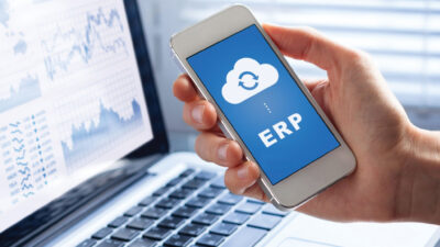 ERP (Enterprise Resource Planning) app on smartphone screen connecting data with cloud computing, access to HR management, production control, accounting
