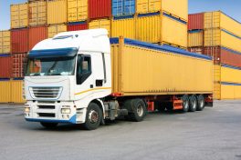 truck in harbor park with cargo containers