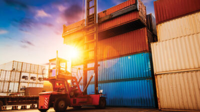 Crane lifting up container in yard
