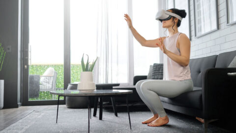 VR, metaverse and futuristic with a woman in the living room of her home using a headset to access a 3d game. Technology, virtual reality and gaming with a female gamer using ai to access games