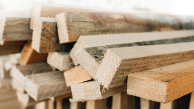 Stacked rustic wooden boards as construction material, selective focus