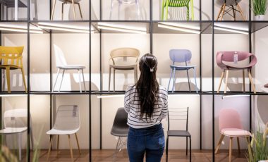 Rear view of a Latin American woman buying chairs at a furniture store - business concepts