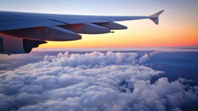 Auckland, New Zealand - May 15, 2016: Looking out the window of an Airbus A380-800 jet airplane at sunset during flight. Photo taken in the evening over the Tasman sea after leaving Auckland International Airport New Zealand