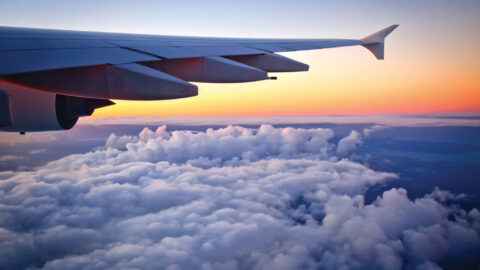 Auckland, New Zealand - May 15, 2016: Looking out the window of an Airbus A380-800 jet airplane at sunset during flight. Photo taken in the evening over the Tasman sea after leaving Auckland International Airport New Zealand