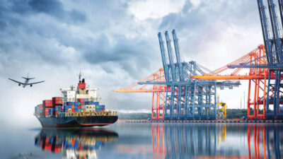 Container Cargo ship and Cargo plane with working crane bridge in seaport , logistic import export background and transport industry.
