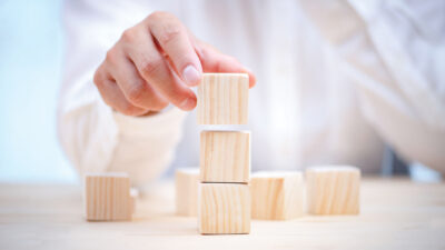 Hand of a businessman chooses a smiley face on wood block cube, The best excellent business services rating customer experience, Satisfaction survey concept